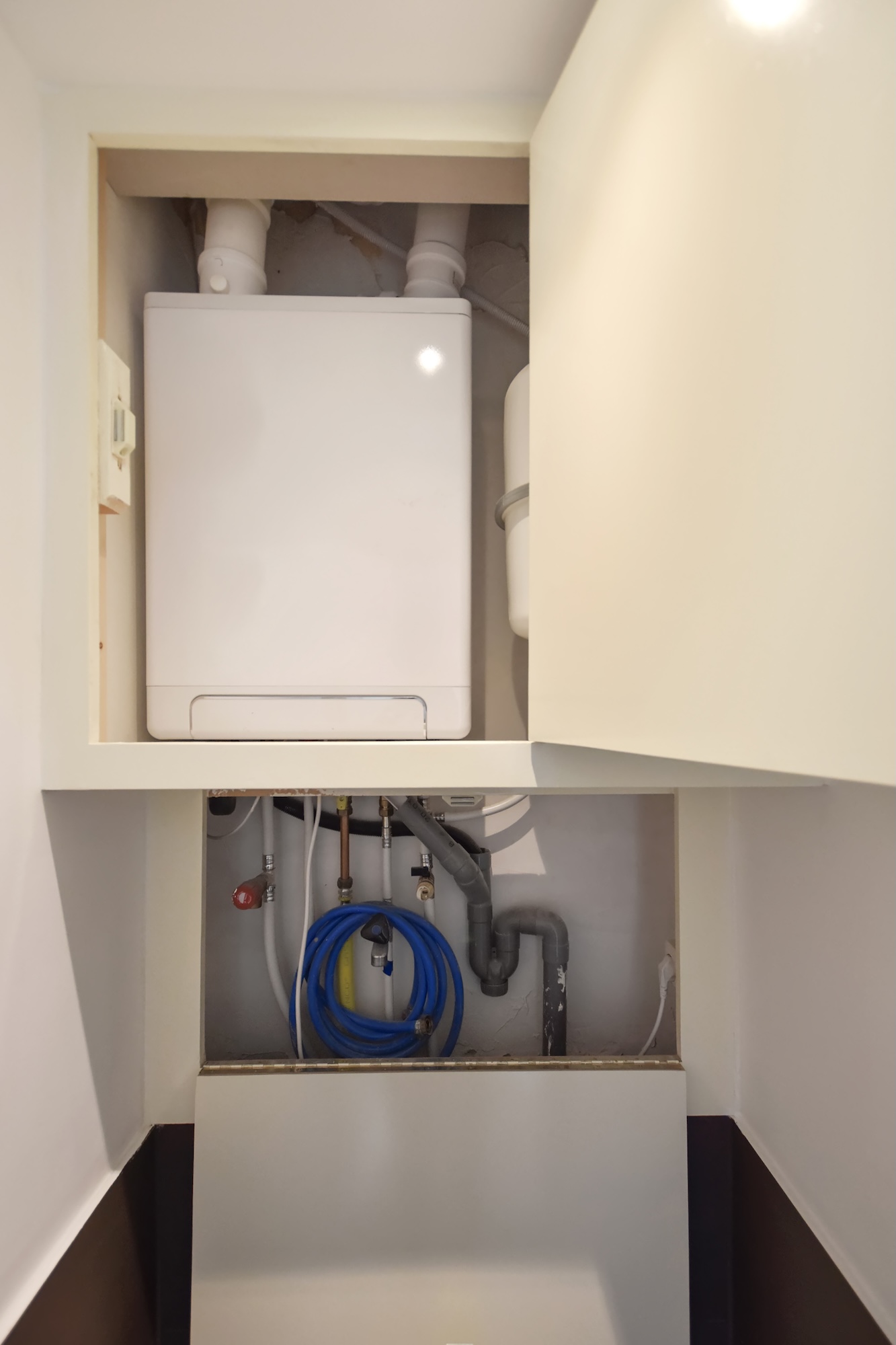 New boiler that has been installed in a home within a cupboard New boiler that has been installed in a home within a cupboard