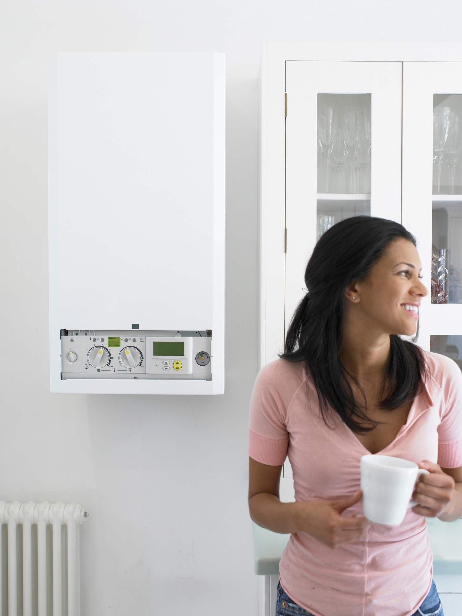Woman in kitchen with new boiler installed in Canterbury Woman in kitchen with new boiler installed in Canterbury